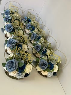 cupcakes decorated with blue and white flowers are arranged in the shape of a heart