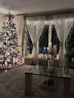 a living room with a christmas tree in the corner and lights on the windowsill