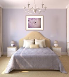 a bedroom with a chandelier, bed and pictures on the wall above it