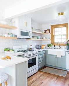 a kitchen with wooden floors and white cabinets