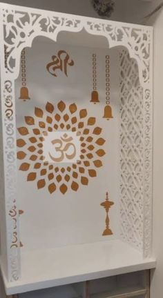 a white shelf with gold designs on it