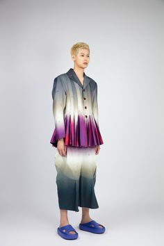 GENDER NEUTRAL Introducing the " DAWN PLEATS JACKET " jacket, a truly one-of-a-kind masterpiece that will elevate your style to new heights. This show-stopping piece features a mesmerising colour gradient print that captures the ethereal hues of dawn breaking over the horizon.The jacket's silhouette is inspired by the intricate, layered petals of the morning glory flower. Its all-around pleat design adds volume, texture, and movement to the garment. The pleats are carefully crafted to create a sense of fluidity as if the jacket is unfolding like a flower in bloom.The fit is bold and playful, with a slightly oversized silhouette that pairs perfectly with the matching print trousers.Every detail of the " DAWN PLEATS JACKET " jacket has been carefully considered to create a truly show-stoppin Tailored Long Sleeve Avant-garde Outerwear, Avant-garde Tailored Long Sleeve Outerwear, Tailored Avant-garde Long Sleeve Outerwear, Avant-garde Long Sleeve Blazer For Spring, Avant-garde Tailored Long Sleeve Blazer, Tailored Long Sleeve Avant-garde Blazer, Colour Gradient, Gradient Print, Pleated Jacket