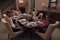 a group of people sitting around a dinner table