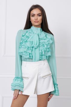 "This is the perfect shirt to add to your wardrobe! It's a versatile piece that can be dressed up or down. The mock-neck and ruffles give it a touch of elegance, while the mint color is unique and eye-catching. The shirt is also extremely comfortable and sheer, making it a great option for layering. Add this shirt to your wardrobe and enjoy the endless possibilities! MODEL INFO: Our model is 5'8 (173 cm.) and wearing size S. SIZES: XS, S, M, L, XL and Custom Size (Please, check the measurements Elegant Green Shirt For Spring, Elegant Green Spring Shirt, Trendy Spring Shirt For Office, Trendy Office Shirt For Spring, Spring Party Collared Shirt, Spring Party Shirt With Collar, Feminine Green Tops For Workwear, Chic Ruffled Button-up Top, Chic Long Sleeve Ruffled Shirt