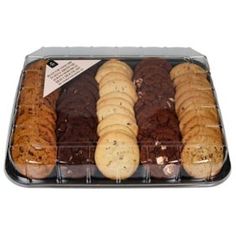 a tray filled with lots of different types of cookies and brownies on top of each other