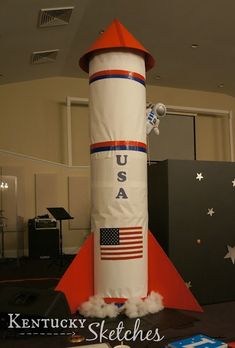 an american flag rocket sitting on top of a table