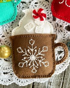 a coffee cup ornament on a doily