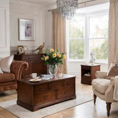 a living room filled with furniture and a chandelier