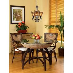 a dining room table with chairs and a chandelier hanging from it's ceiling