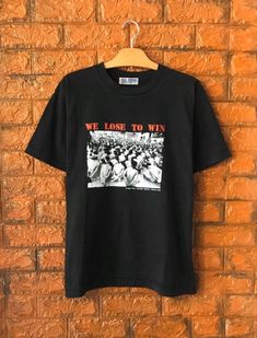 Vintage 90s Black May Thailand Protest History Photoprint Art T Shirt / Vintage Punk T Shirt / Human Right Protest / Art T Shirt Size MCondition : Good Used Size on tag : MColour : blackBrand :  soda creamMeasurement : Armpit to armpit -21”Length - 27”Material : Old CottonMade In: Unknown THE SHIPPING (Your Choice Please read)1. The shipping cost is USD 20 via Malaysian Registered Postage With Tracking Number.It will take 2-4 weeks or more for delivery, depends on your custom checking.2. Add USD 90s Style Black Top With Graffiti Print, 90s Style Black Deadstock Tops, 90s Style Crew Neck T-shirt For Alternative Fashion, Vintage Black T-shirt With Graphic Design, 90s Crew Neck T-shirt For Alternative Fashion, Vintage Graphic Print T-shirt For Alternative Fashion, 90s Black Top With Graffiti Print, 90s Black Tops With Graffiti Print, Retro Screen Print T-shirt For Alternative Fashion