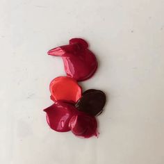 three hearts shaped like birds sitting on top of each other in front of a white background