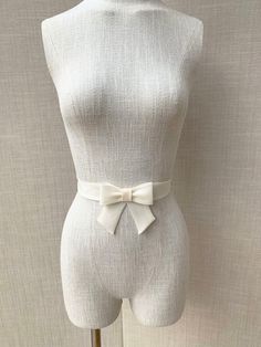 This super elegant delicate bridal belt is beautifully hand made out of silk organza. It features center bow detail with the hanging tails. The belt is finished in the back with the hidden clasp. Available in white, off white or ivory, please see the last photo for the color reference. This belt measures 1 1/4" wide and the length is finished to your measurements. Shown in the photos in ivory. We can make this belt in any other color if needed, please inquire about the custom order. * Please inc Elegant Bridal Accessories With Satin Bow, Elegant Adjustable Sashes For Formal Occasions, Elegant Adjustable Sash For Formal Occasions, Elegant Ribbon Bridal Belt For Wedding, Elegant Formal Adjustable Sash, Elegant Formal Adjustable Sashes, Elegant Bridal Belt For Bridesmaid, Elegant Fitted Bridal Belt, Elegant Bridal Belt With Satin Bow For Wedding