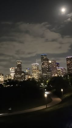 the city skyline is lit up at night