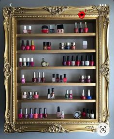 an ornate gold framed display with nail polish bottles