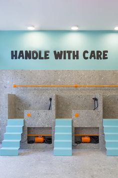 the inside of a hair salon with blue and orange stools