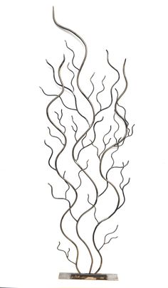 a metal sculpture is shown against a white background and has wavy lines in the shape of leaves