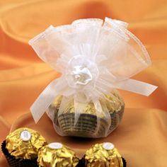 two chocolate cupcakes wrapped in cellophane and sitting next to each other