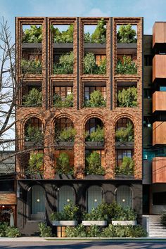 an apartment building with plants growing on the windows