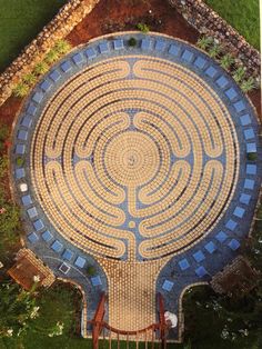 an aerial view of a circular garden design in the middle of a yard with stairs leading up to it