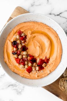 a white bowl filled with hummus and vegetables