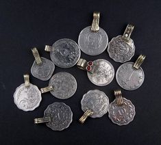 Take a look at this beautiful set of vintage Afghani and Pakistani coins. Each set features 8 individual pieces. These coins have been turned into pendants. Each is different and unique and may be used for earings, bracelets, necklaces, or can be worn as is. It's common practice for belly dancers to incorporate this piece into their costumes. Set of coins will VARY from set pictured. Most pendants do NOT have rhinestone color pieces. Number of round other shaped pendants may vary. Silver Coin Jewelry, Jewelry Rings Unique, Silver Jewellery Sets, Silver Jewels, Old Coins, Silver Jewelry Pendant, Coin Jewelry, Silver Jewelry Rings, Old Jewelry