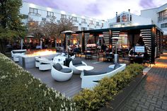 an outdoor seating area with tables and chairs