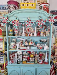 an old china cabinet is decorated with red, white and blue decorations