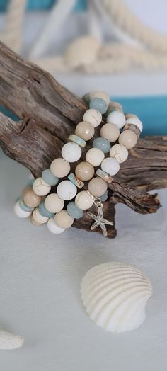 TitiTataStore.com Always FREE SHIPPING and a FREE GIFT! I Will Ship Within 24 Hours. Description:  A Set of 3 Beachy Style Handmade Bracelets.  Beautiful Summer Beach Vacation Vibes! Materials: 8mm Beige Faceted Jade Beads, 8mm Rondelle Blue Quartz Beads, 8mm Matte White Magnesite Beads, 8mm Ivory Matte Jasper Beads, 8mm Natural White Matte Turquiose Beads, 8mm Wood Beads and, 8mm Sea Sediment Jasper Heishi Beads.  A lovely starfish charm complement this beachy set.  Every bracelet is handmade using a high-quality elastic stretch cord for durability. Size: Each bracelet is suitable for a small wrist circumference of about 7".    Final Touch: Your bracelet will be nicely packed in a Burlap Gift Bag. ❤ All orders are shipped FREE via USPS First Class Mail with tracking number. ❤ If you would Spiritual White Friendship Bracelets For Beach, Spiritual White Stretch Bracelet For Beach, Turquoise Beaded Bracelets With 8mm Beads For Beach, Bohemian White Stretch Bracelet For Beach Season, White Coastal Style Bracelet For Gift, White Bohemian Stretch Bracelet For Beach Season, Adjustable Spiritual Stretch Bracelet For Beach, Spiritual 8mm Beads Jewelry For Beach, Spiritual Multicolor Stretch Bracelet For Beach