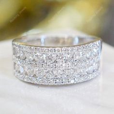 a white gold ring with rows of diamonds