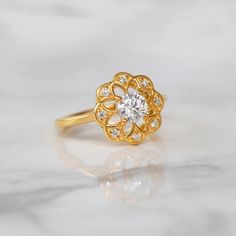 Sometimes when a girl says she likes to receive flowers as a gift, it's not the real flowers she means. Think twice and go for the safest thing - our Flora ring with Moissanite. Floral jewelry is where it's at! Perfect as a graduation gift, birthday gift, anniversary ring, or a promise ring. Details: Center stone Gemstone: Moissanite Stone Shape: Round Measurements: 5.00mm Side stones Gemstone: Moissanite Shape: Round Measurements: 1.30mm (8) Band measurements: approx. 1.8mm wide, approx. 1.5mm Elegant Flower Ring With Prong Setting For Proposal, Elegant Flower Ring With Brilliant Cut For Gift, Elegant Brilliant Cut Flower Ring Gift, Flower Shaped Diamond Ring For Wedding, Gift Elegant Flower Ring With Brilliant Cut, Diamond Flower Ring With Halo Design For Promise, Flower Ring With Rose Cut Diamonds For Gifts, Flower-shaped Diamond Promise Ring, Flower-shaped Wedding Ring With Prong Setting