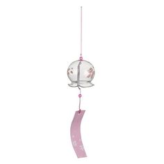 a wind chime with a pink ribbon hanging from it's side and a glass ball in the middle