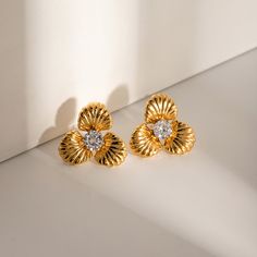 Get your hands on a 1-pair set of 18K gold-plated, Stainless steel, Zircon earrings that measure 1 inch in length and weigh in at a sassy 0.3 oz (or 8.96 g). Aesthetic Earrings, Petal Flower, Flower Earrings Studs, Flower Studs, Girls Jewelry, Gold Jewelry Fashion, Flower Fashion, Gold Earrings Studs, Flower Shape