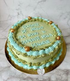 a cake that is sitting on top of a marble table with writing on the frosting