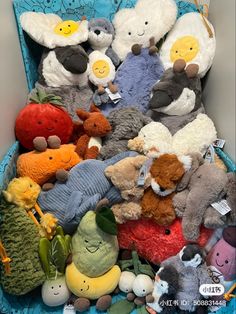 a pile of stuffed animals sitting on top of a blue chair