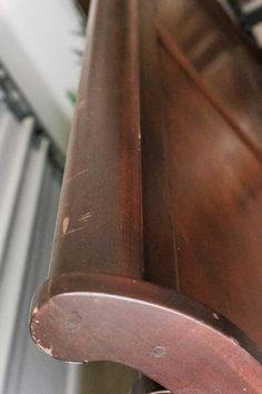 an old wooden bench sitting in front of a window