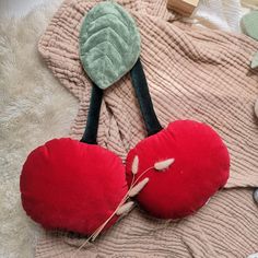 two heart shaped cushions on top of a blanket