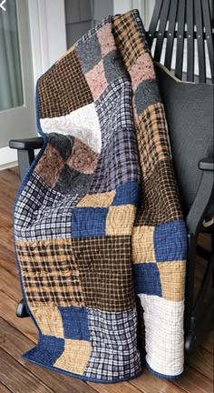 a chair with a blanket on top of it sitting next to a wooden floor and door