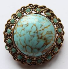 -Vintage Austria Gold Tone Glass Bead Pin Brooch -Total size: 1.25 in -Middle glass bead size: 1 in -Marked Austria -In good vintage condition but need to be clean Vintage Blue Brooches For Jewelry Making, Vintage Blue Brooch Pin, Antique Handmade Blue Brooches, Handmade Vintage Turquoise Brooches, Handmade Turquoise Brooches For Collectible, New City, Turquoise Color, Blue Turquoise, Pin Brooch