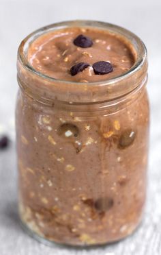 a jar filled with chocolate pudding on top of a table