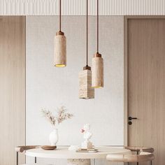 a dining room table with three hanging lights above it