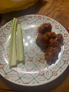 a white plate topped with meat and celery