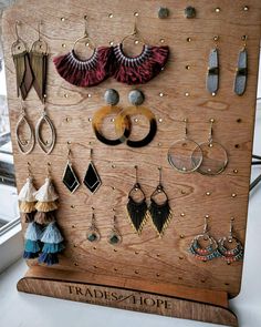 there is a wooden board with earrings on it