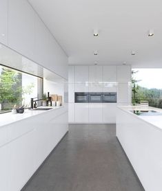 an empty kitchen with white cabinets and counter tops is seen in this image from the inside