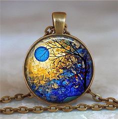 "Winter Blue Moon pendant (Listing 85) This beautiful abstract painting depicts a blue moon framed by bare branches and blue crystals -- perfect for nature lovers and those looking to commemorate a special one-in-a-blue-moon occurrence. At checkout you can choose between pendant only, pendant with chain, or key chain with swivel hook. Matching cross-link chains are available in five lengths (18\", 21\", 24\", 27\" and 30\"). Our artwork and maps are printed using archival inks and papers and pro