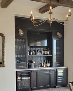 a bar with lots of bottles and glasses on it in a room that has a piano