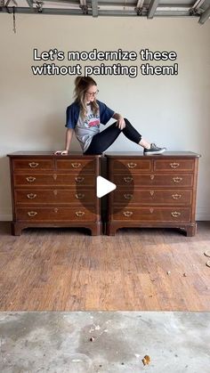 a woman sitting on top of a wooden dresser next to a wall with the words let's modernize these without painting them