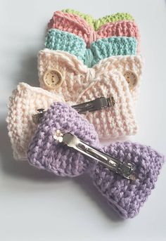 four crocheted hair clips laying on top of each other