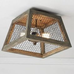 a light fixture with chicken wire on it