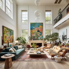 a living room filled with lots of furniture and large paintings on the wall above it