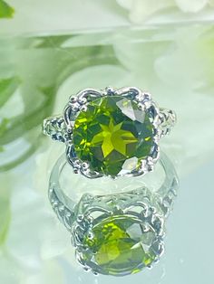 Natural Green Peridot Ring  Speechless Design#103 MADE TO ORDER Inspired by Victorian era filigree designs, I now offer this stunning Antique inspired ring in sterling silver (Solid 10K and 14K gold option also now available) at wholesale pricing. This fabulous ring is set with a 6ct stunning natural green peridot gemstone (AA to AAA clarity). The round full cut high-quality gemstone is 12mm (just shy of 1/2th of an inch) in diameter, and has very good color and clarity. The inside of the band i Classic Peridot Jewelry With Prong Setting, Classic Peridot Jewelry For May Birthstone, Green Peridot Jewelry With Prong Setting, Lime Green Gemstone Ring Jewelry, Lime Green Gemstone Ring, Formal Lime Green Peridot Jewelry, Elegant Peridot Jewelry With Prong Setting, Classic Round Cut Peridot Jewelry, Peridot Center Stone Jewelry For May Birthstone